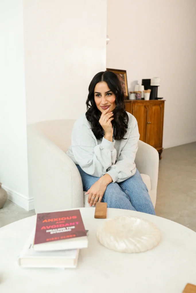 Natasha Wahi seated in a calm therapy office at MySahaaya Healing and Wellness, promoting emotional healing and personal growth.